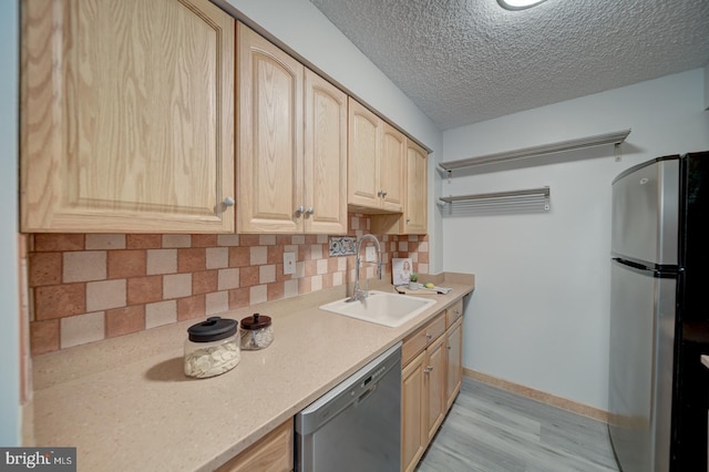 5300 Holmes Run Pkwy Unit 709, Alexandria, VA 22304 - kitchen with stainless steel appliances, light brown cabinetry, decorative backsplash, light countertops, and a textured ceiling