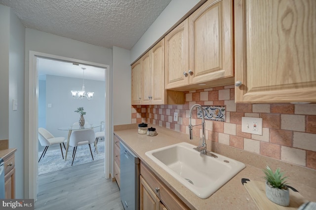 5300 Holmes Run Pkwy Unit 709, Alexandria, VA 22304 - kitchen featuring dishwasher, light brown cabinetry, light wood-style flooring, light countertops, and tasteful backsplash
