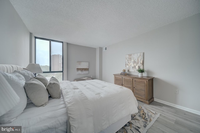 5300 Holmes Run Pkwy Unit 709, Alexandria, VA 22304 - bedroom with light wood-style flooring and a textured ceiling