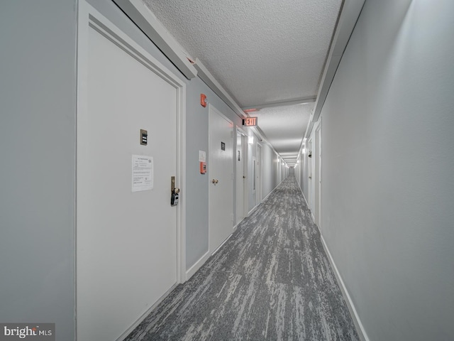 5300 Holmes Run Pkwy Unit 709, Alexandria, VA 22304 - corridor featuring a textured ceiling and dark colored carpet