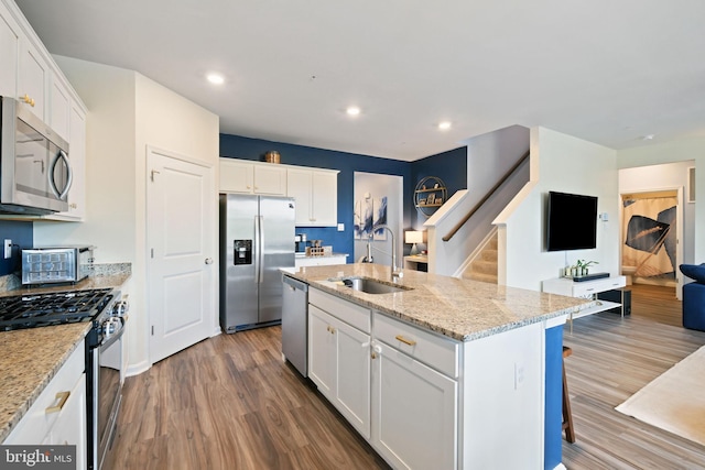 2014 Fauna Dr, Frederick, MD 21702 - kitchen with stainless steel appliances, wood finished floors, white cabinets, an island with sink, and recessed lighting