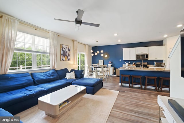 2014 Fauna Dr, Frederick, MD 21702 - living room featuring healthy amount of natural light, a chandelier, a ceiling fan, recessed lighting, and light wood-type flooring