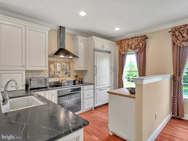 42 Bissenden Way, Reinholds, PA 17569 - kitchen featuring wall chimney exhaust hood, black appliances, decorative backsplash, crown molding, and white cabinets