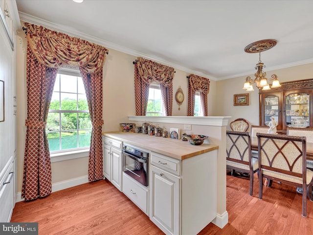 42 Bissenden Way, Reinholds, PA 17569 - kitchen featuring a peninsula, light wood-type flooring, crown molding, oven, and white cabinets