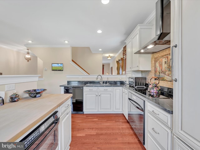 42 Bissenden Way, Reinholds, PA 17569 - kitchen featuring wall chimney range hood, dishwashing machine, black electric stovetop, white cabinets, and crown molding