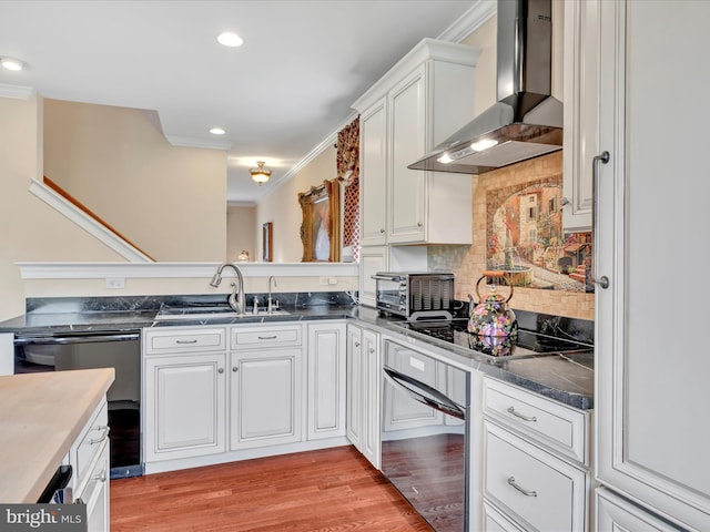 42 Bissenden Way, Reinholds, PA 17569 - kitchen with wall chimney range hood, dishwashing machine, crown molding, white cabinets, and light wood finished floors