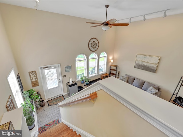42 Bissenden Way, Reinholds, PA 17569 - stairway featuring rail lighting, a ceiling fan, wood finished floors, and a towering ceiling