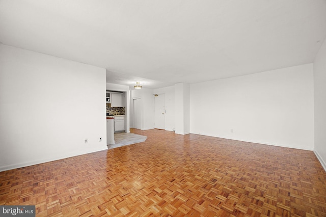 1301 N Harrison St Unit 1106, Wilmington, DE 19806 - unfurnished living room featuring baseboards