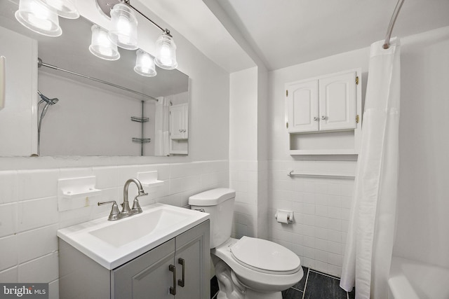 1301 N Harrison St Unit 1106, Wilmington, DE 19806 - bathroom featuring tile walls, vanity, wainscoting, and shower / tub combo