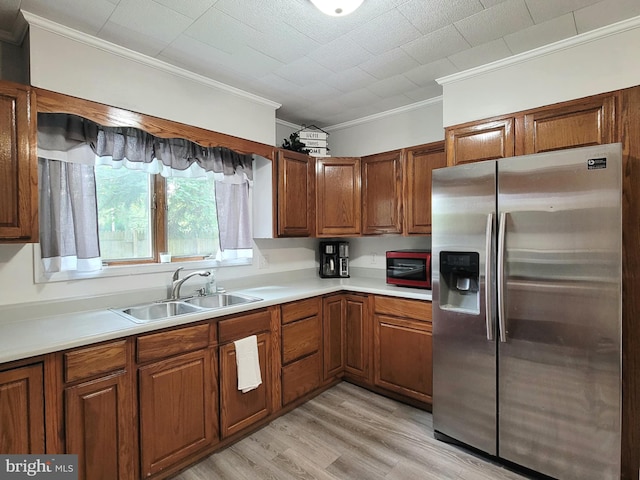 189 Rolling Stone Rd, Kylertown, PA 16847 - kitchen featuring stainless steel refrigerator with ice dispenser, ornamental molding, brown cabinets, and light wood-type flooring