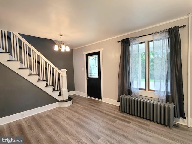 189 Rolling Stone Rd, Kylertown, PA 16847 - entrance foyer featuring radiator heating unit, a chandelier, stairway, wood finished floors, and ornamental molding
