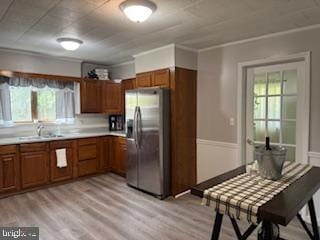 189 Rolling Stone Rd, Kylertown, PA 16847 - kitchen with stainless steel refrigerator with ice dispenser, brown cabinetry, light countertops, and light wood finished floors