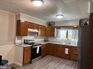 189 Rolling Stone Rd, Kylertown, PA 16847 - kitchen with stainless steel appliances, under cabinet range hood, brown cabinets, light countertops, and crown molding