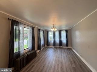 189 Rolling Stone Rd, Kylertown, PA 16847 - unfurnished room with radiator, a chandelier, dark wood-style flooring, and ornamental molding