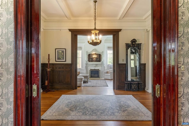 2024 Rivermont Ave, Lynchburg, VA 24503 - foyer featuring a chandelier, wood finished floors, wainscoting, ornamental molding, and a fireplace