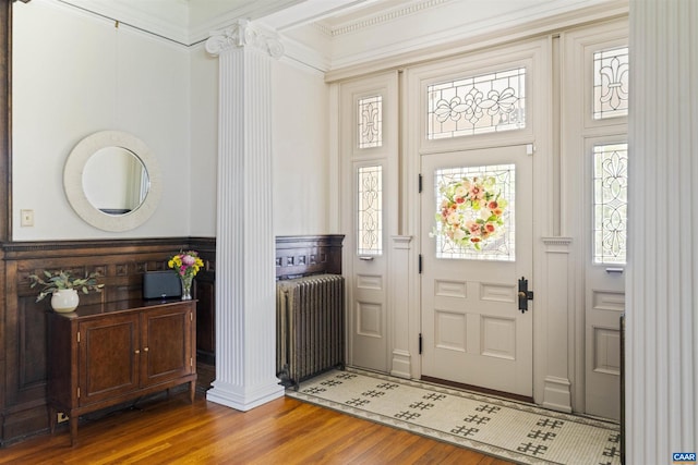 2024 Rivermont Ave, Lynchburg, VA 24503 - entryway featuring wood finished floors, radiator, decorative columns, wainscoting, and ornamental molding