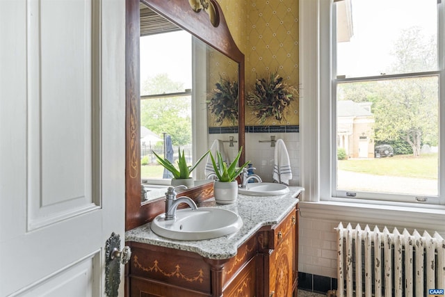 2024 Rivermont Ave, Lynchburg, VA 24503 - bathroom featuring radiator heating unit, tile walls, and double vanity