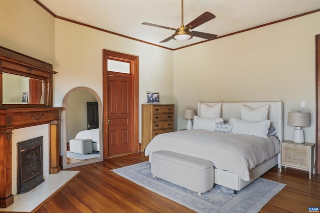 2024 Rivermont Ave, Lynchburg, VA 24503 - bedroom with a fireplace with flush hearth, dark wood-type flooring, ornamental molding, arched walkways, and a ceiling fan