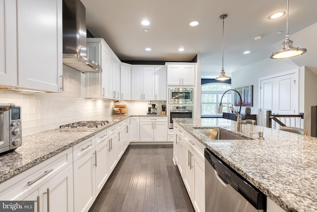 6006 Charles Xing, Ellicott City, MD 21043 - kitchen featuring appliances with stainless steel finishes, wall chimney range hood, recessed lighting, white cabinetry, and pendant lighting