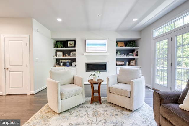 6006 Charles Xing, Ellicott City, MD 21043 - living area featuring a glass covered fireplace, wood finished floors, recessed lighting, and built in shelves