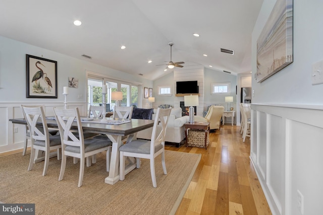 1510 N Bay Shore Dr, Milton, DE 19968 - dining space featuring ceiling fan, a decorative wall, light wood finished floors, a wainscoted wall, and lofted ceiling