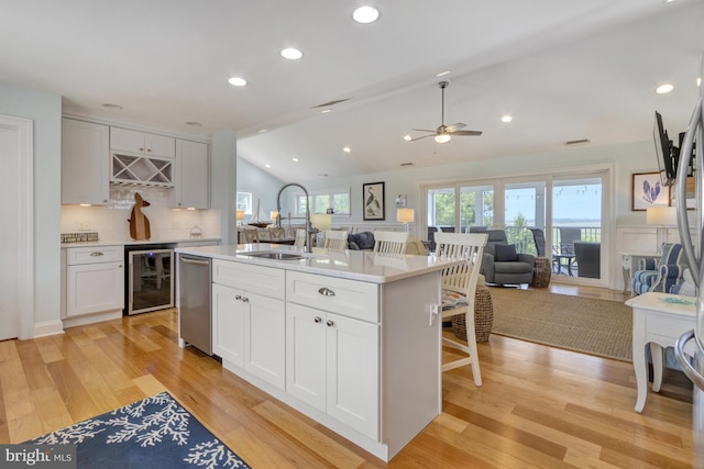 1510 N Bay Shore Dr, Milton, DE 19968 - kitchen with wine cooler, open floor plan, lofted ceiling, ceiling fan, and light countertops