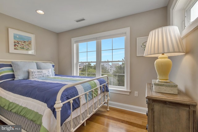 1510 N Bay Shore Dr, Milton, DE 19968 - bedroom with multiple windows, wood finished floors, and recessed lighting