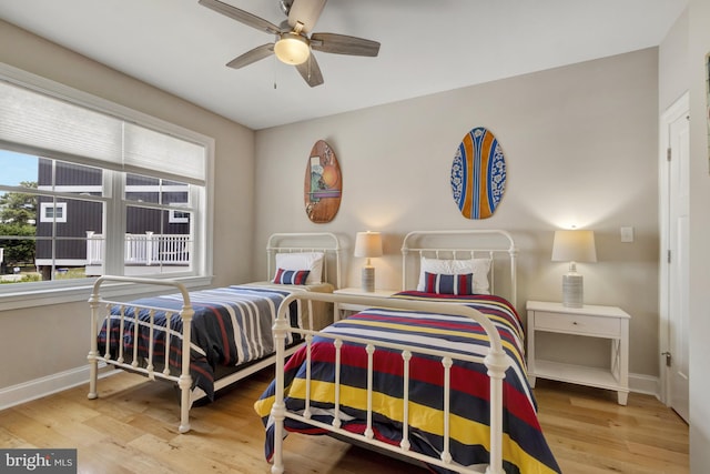 1510 N Bay Shore Dr, Milton, DE 19968 - bedroom featuring multiple windows, wood finished floors, and ceiling fan