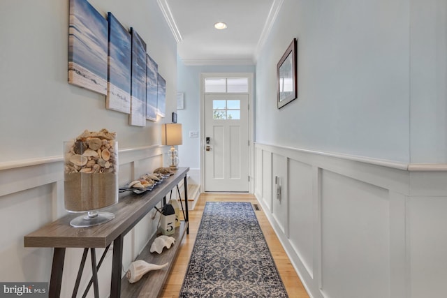1510 N Bay Shore Dr, Milton, DE 19968 - doorway to outside featuring crown molding, a decorative wall, light wood finished floors, wainscoting, and recessed lighting