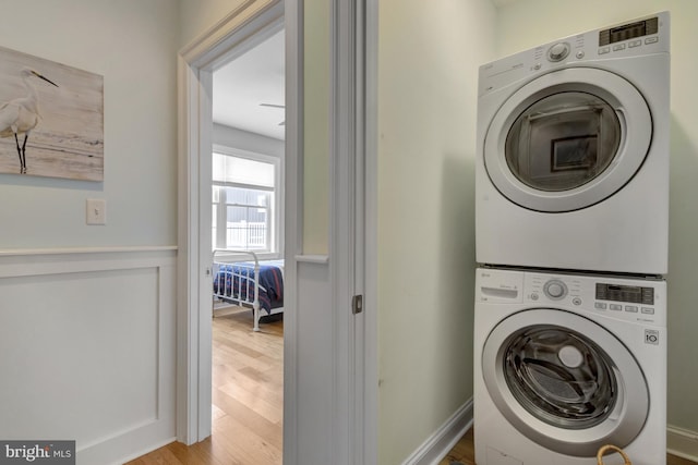 1510 N Bay Shore Dr, Milton, DE 19968 - washroom with stacked washing machine and dryer and wood finished floors