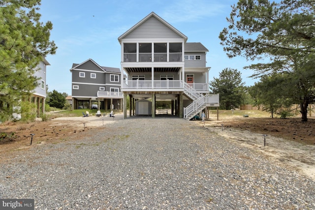 1510 N Bay Shore Dr, Milton, DE 19968 - beach home featuring a carport, stairs, a sunroom, and driveway