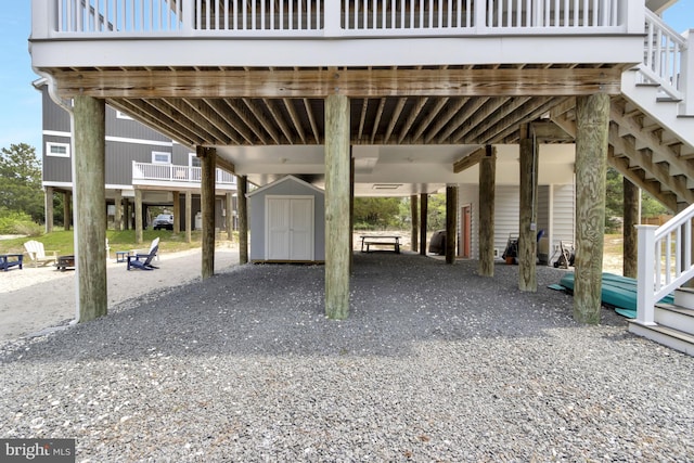 1510 N Bay Shore Dr, Milton, DE 19968 - view of vehicle parking featuring stairs, a storage unit, driveway, and a carport