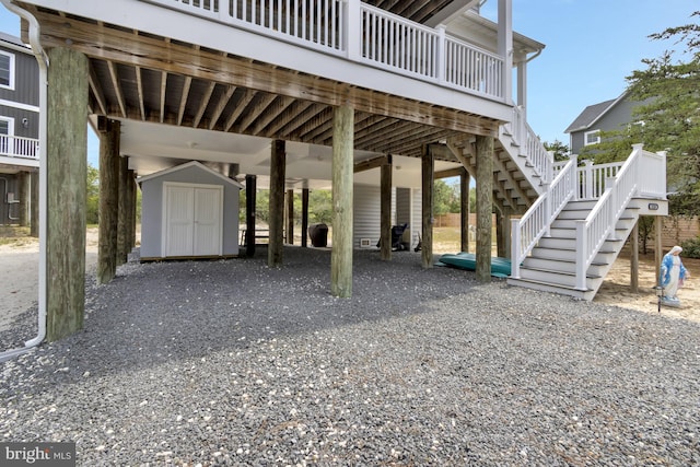 1510 N Bay Shore Dr, Milton, DE 19968 - view of parking / parking lot with a storage unit, stairs, gravel driveway, and a carport