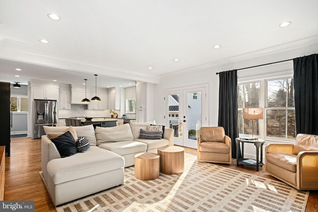810 Cedar Ave, Haddonfield, NJ 08033 - living room with recessed lighting, healthy amount of natural light, light wood finished floors, french doors, and decorative columns