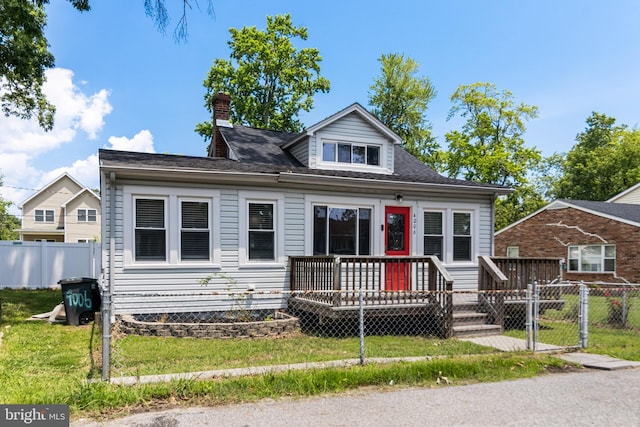 4006 6th St, North Beach, MD 20714 - view of front of home featuring a fenced front yard, a gate, a chimney, and a shingled roof