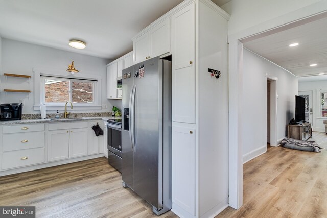 4006 6th St, North Beach, MD 20714 - kitchen featuring stainless steel appliances, white cabinetry, plenty of natural light, light wood finished floors, and recessed lighting
