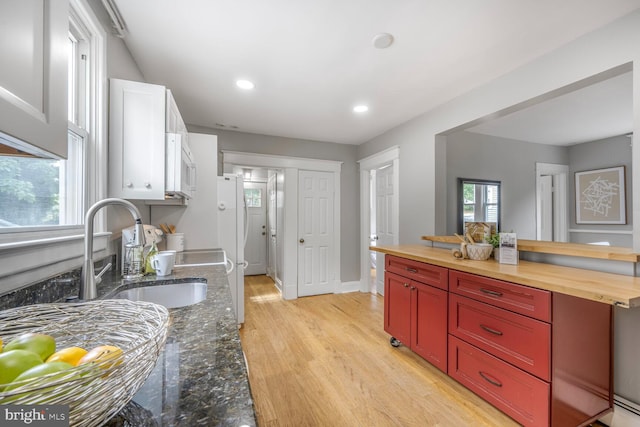 3824 31st St, Mount Rainier, MD 20712 - kitchen featuring butcher block countertops, white microwave, light wood-type flooring, recessed lighting, and white cabinetry