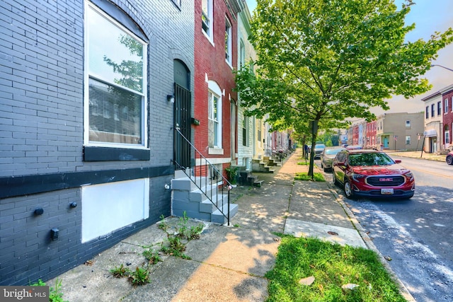 2557 W Baltimore St, Baltimore, MD 21223 - view of side of property featuring entry steps, brick siding, and a residential view