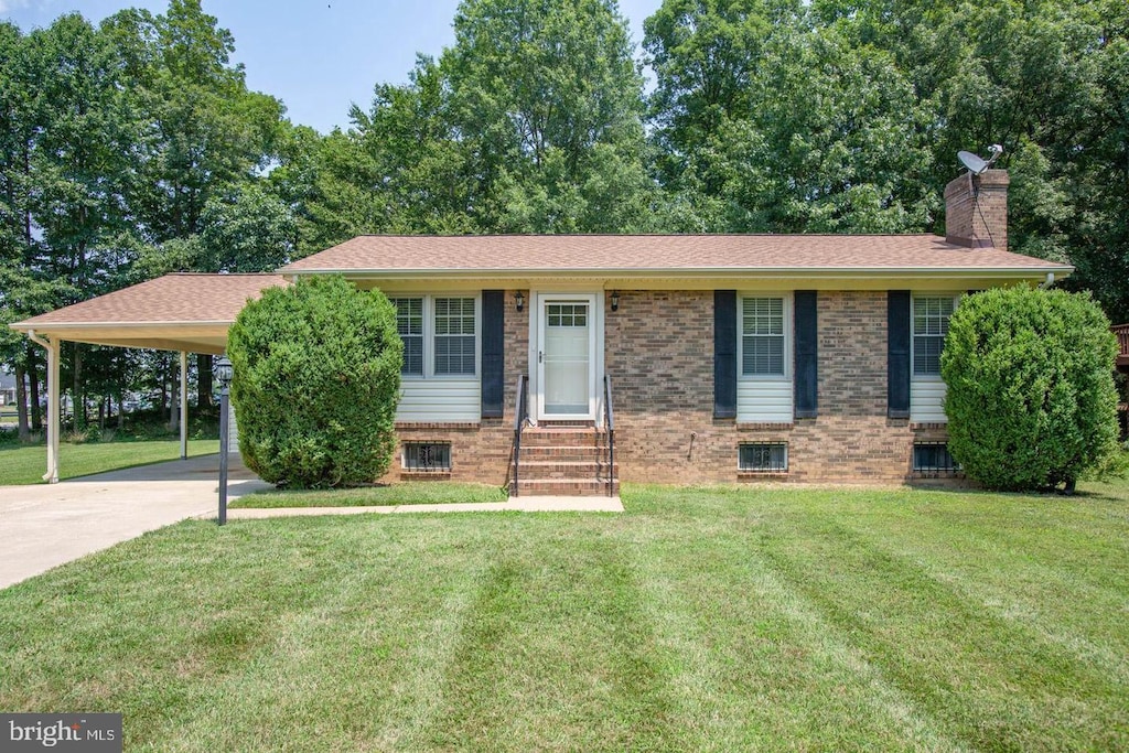 405 Confederate Blvd, Fredericksburg, VA 22401 - view of front of property with entry steps, a chimney, brick siding, a front lawn, and concrete driveway