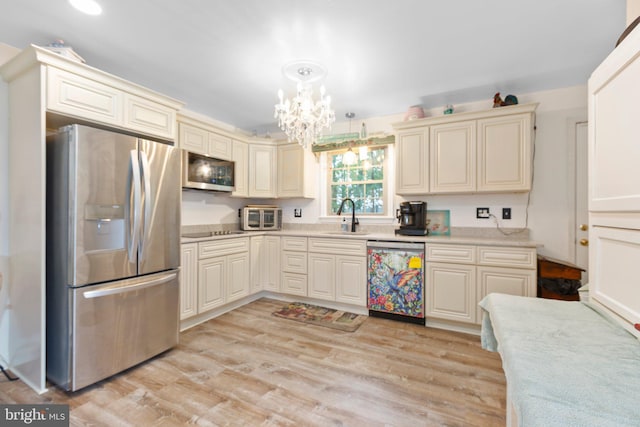 405 Confederate Blvd, Fredericksburg, VA 22401 - kitchen featuring appliances with stainless steel finishes, cream cabinetry, a chandelier, and light wood-style flooring
