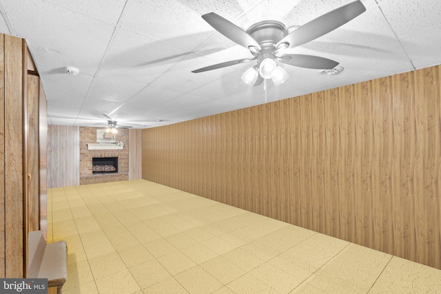 405 Confederate Blvd, Fredericksburg, VA 22401 - unfurnished living room with a fireplace, a drop ceiling, wood walls, and a ceiling fan