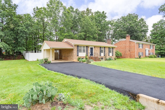 405 Confederate Blvd, Fredericksburg, VA 22401 - view of front facade featuring a chimney, brick siding, asphalt driveway, and a carport