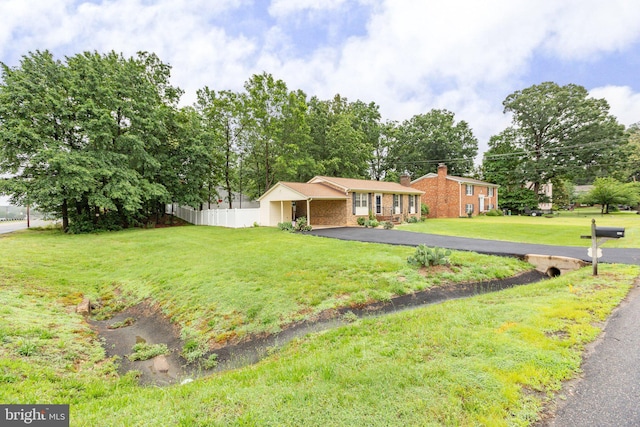 405 Confederate Blvd, Fredericksburg, VA 22401 - view of front facade with a chimney, driveway, and brick siding