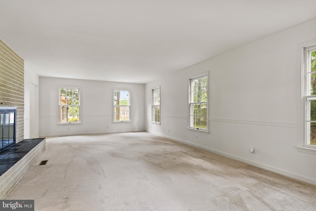 7 Forest Ln, Carlisle, PA 17015 - unfurnished living room featuring a fireplace, carpet, and healthy amount of natural light