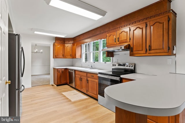 7 Forest Ln, Carlisle, PA 17015 - kitchen featuring appliances with stainless steel finishes, under cabinet range hood, light wood-style flooring, and brown cabinets