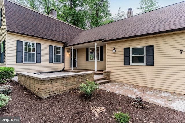7 Forest Ln, Carlisle, PA 17015 - view of front of house with a chimney, a shingled roof, and covered porch
