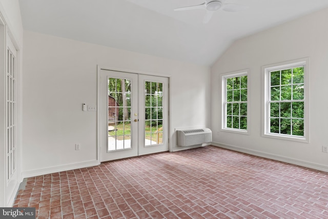 7 Forest Ln, Carlisle, PA 17015 - spare room featuring brick patterned floors, lofted ceiling, a wall unit AC, a ceiling fan, and french doors