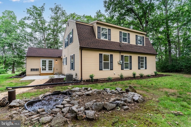 7 Forest Ln, Carlisle, PA 17015 - colonial inspired home with a shingled roof, french doors, a gambrel roof, a front yard, and a patio