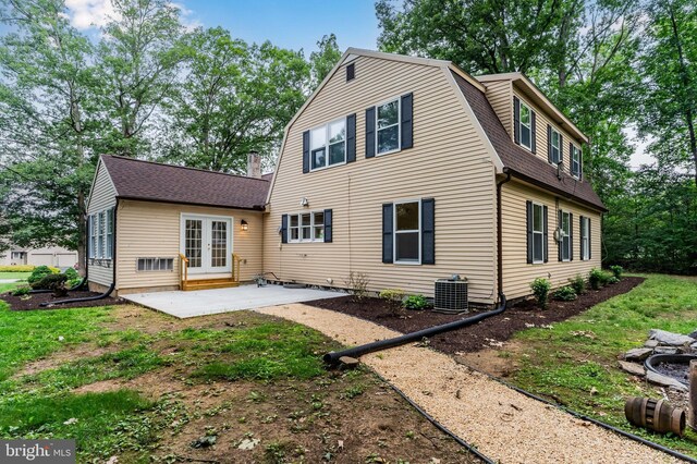 7 Forest Ln, Carlisle, PA 17015 - back of property with french doors, a shingled roof, a patio, and a gambrel roof