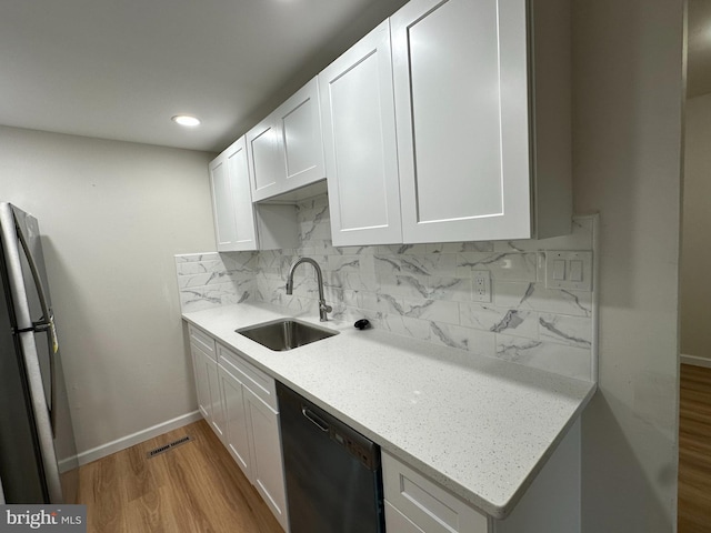 110 Hopkins Ct, Newark, DE 19713 - kitchen with dishwashing machine, freestanding refrigerator, wood finished floors, tasteful backsplash, and white cabinets